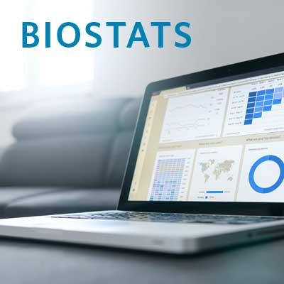 laptop open on table, showing charts and graphs