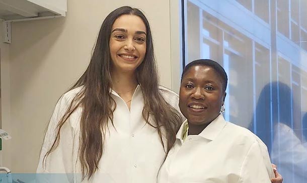 Humeyra Kaanoglu and Adebimpe Adefolaju standing together in lab