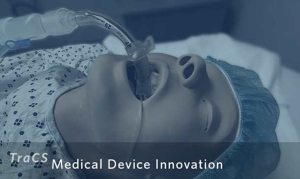 Endotracheal tube prototype connected to mannequin laying on hospital bed