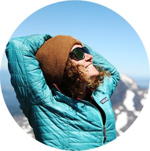 Mary Lide Parker smiling at the sun on the summit of South Sister in southern Oregon.